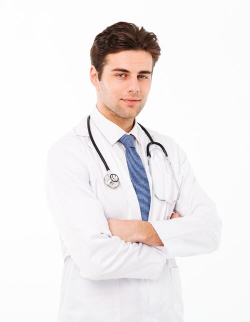 Portrait of a hansome young male doctor with stethoscope dressed in uniform standing with arms folded and looking at camera isolated over white background